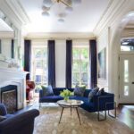 Village-Townhouse-decor-with-large-living-room-and-blue-accent-curtains